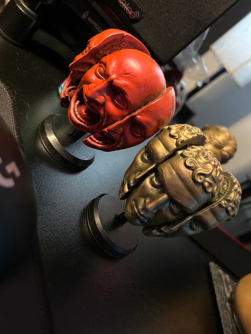 Two painted resin orbs on display stands, photo by the customer