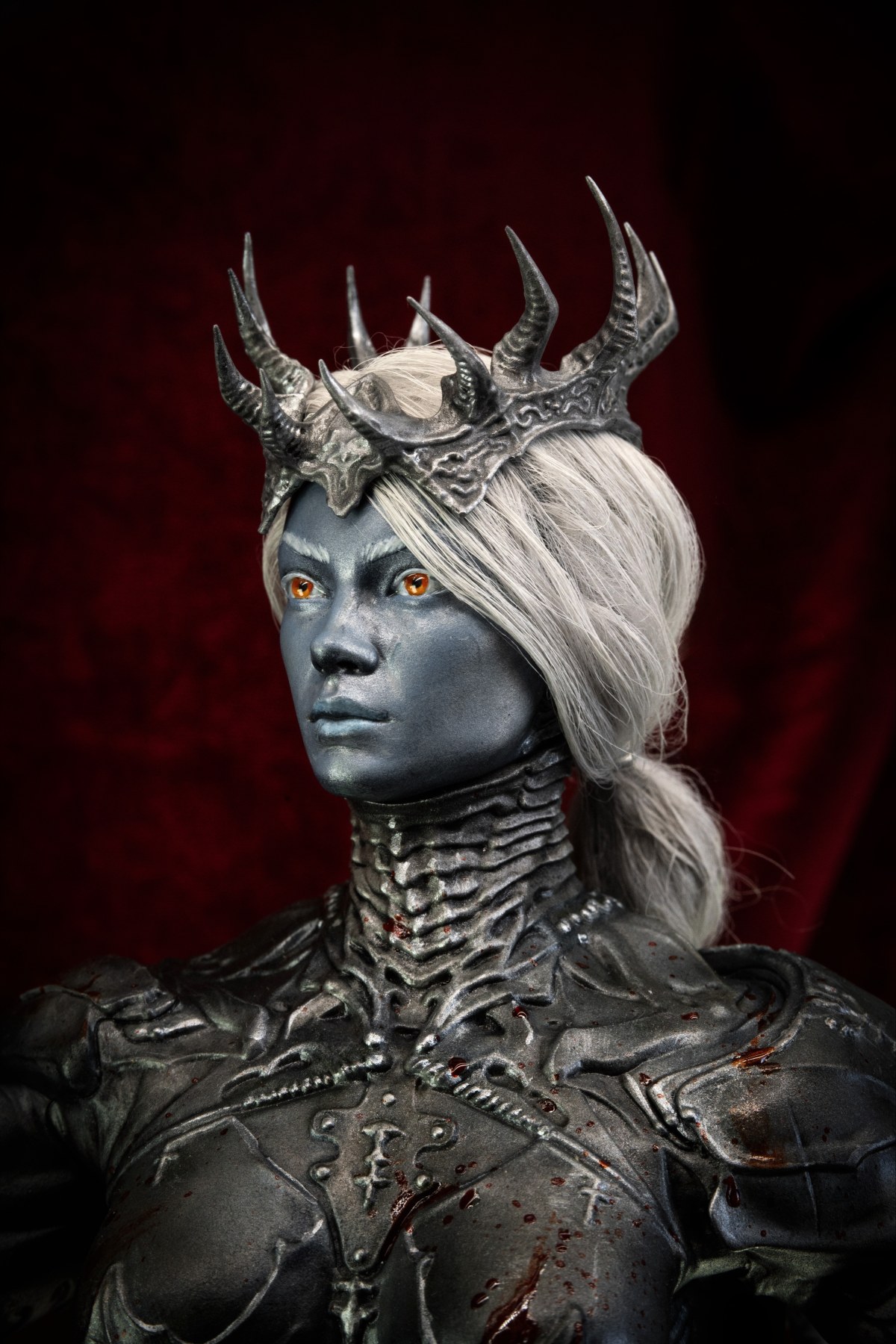 The Steelforged Maiden, Battle‑worn warrior over a beheaded monster